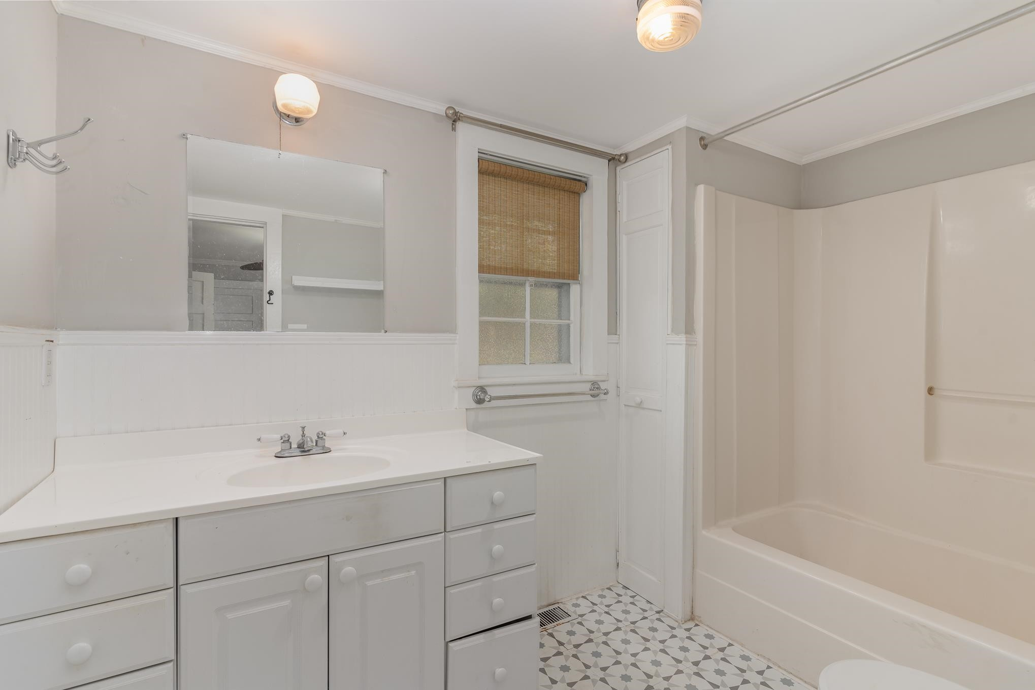 519 Holden Street Raleigh, NC 27604 - Photo 16 of 23 a bathroom with a bathtub sink vanity and mirror