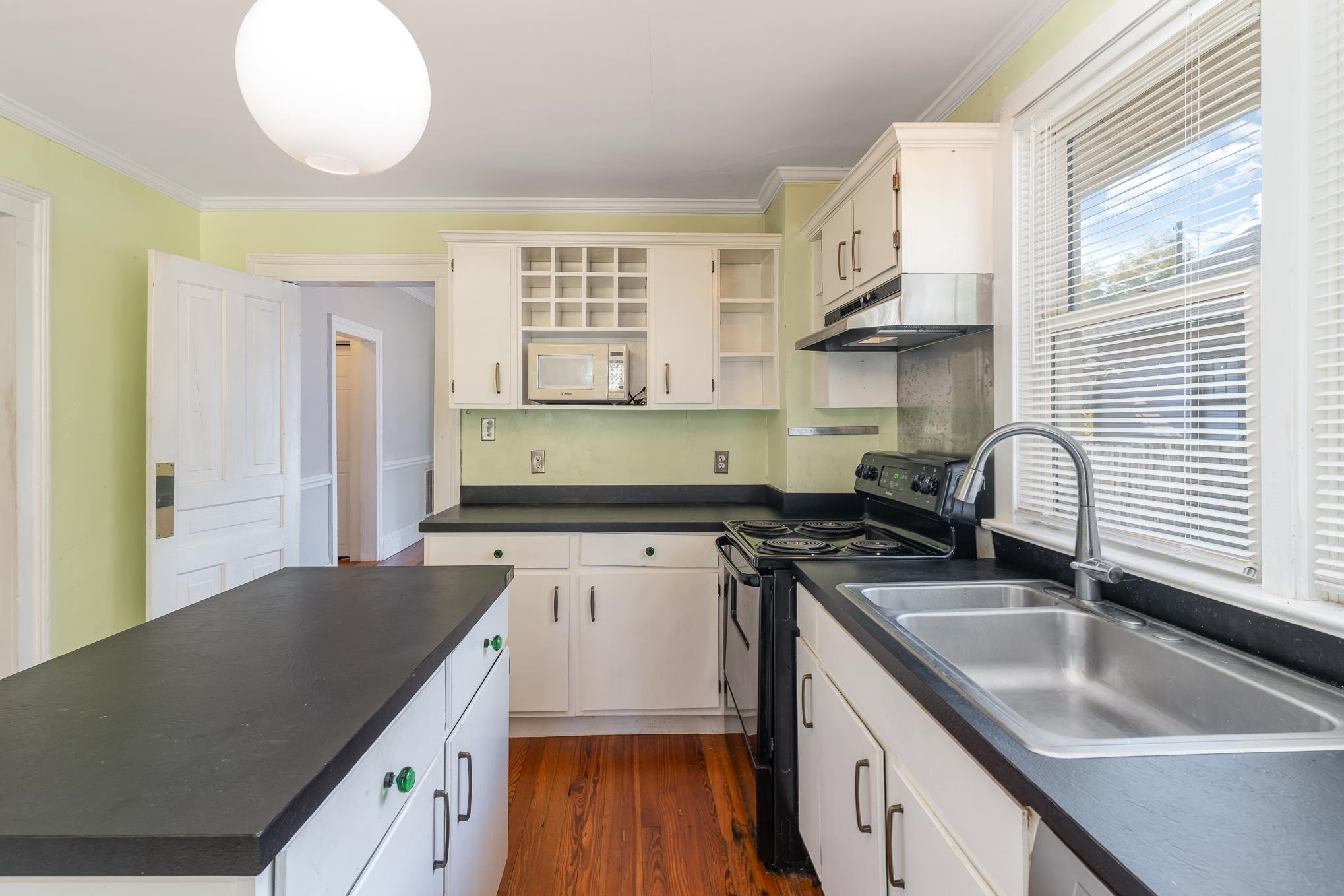 519 Holden Street Raleigh, NC 27604 - Photo 9 of 23 a kitchen with a sink stove and cabinets