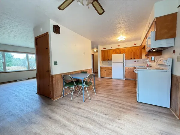 an open kitchen with a table and chairs in it