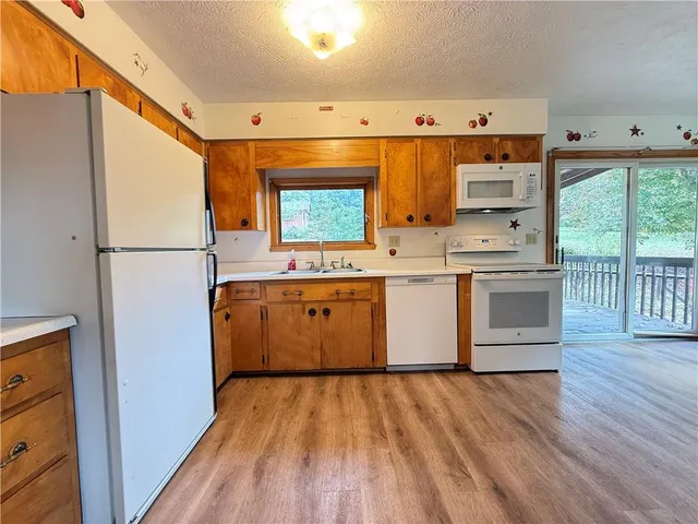 a room with wooden floors and white walls