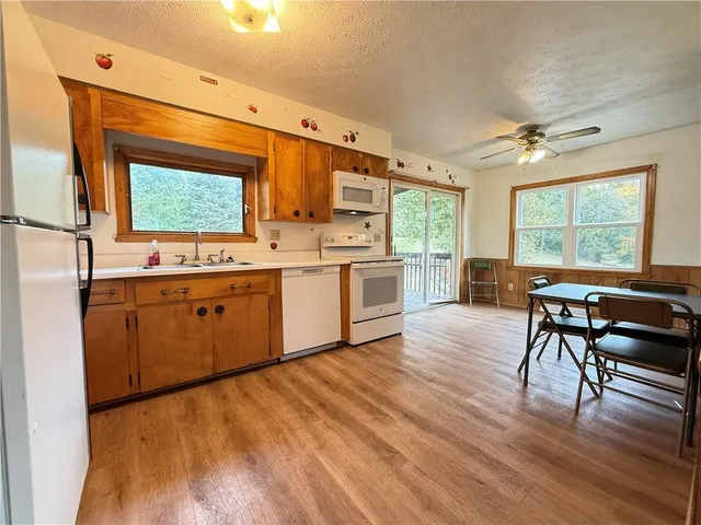 a kitchen with a table chairs and wooden floors