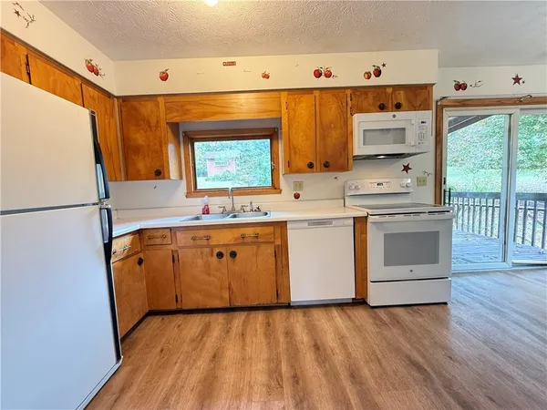 a kitchen with stainless steel appliances a stove top oven