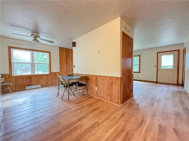 a furnished livingroom with windows and wooden floor