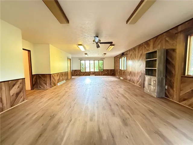 a view of a room with wooden floor