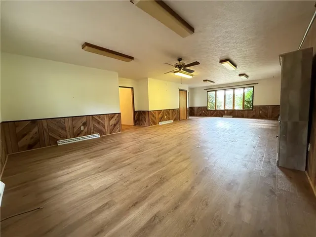 a bathroom with a granite countertop toilet a sink and a mirror