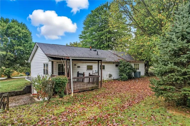 a view of a house with a yard and potted plants