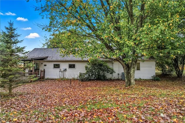 a house that has a tree in front of it