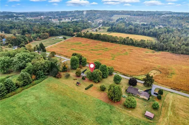 an aerial view of ocean with residential house and lake view