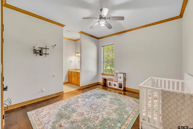 a spacious bedroom with a bed and a dresser