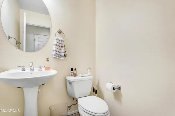 a bathroom with a sink mirror and toilet