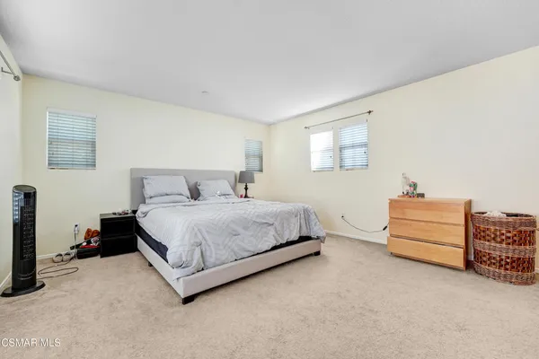 a bedroom with a bed and a tv