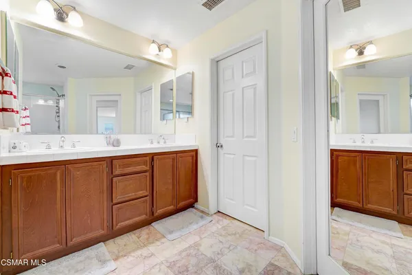 a bathroom with a tub sink and shower