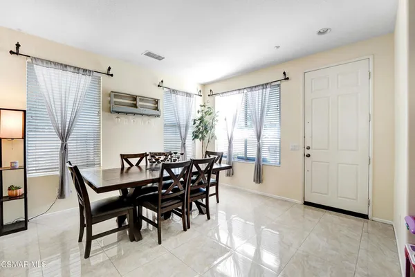 a dining room with furniture and window