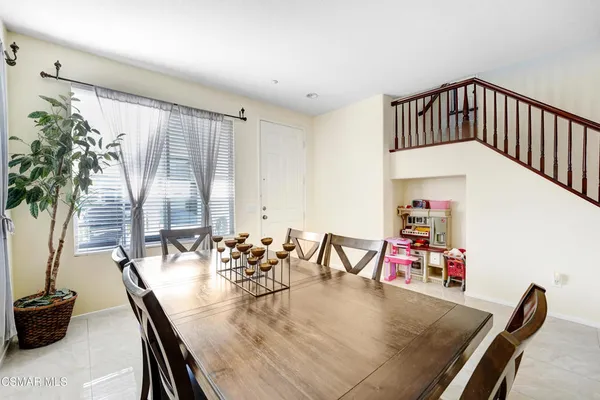 a view of a dining room with furniture and a potted plant