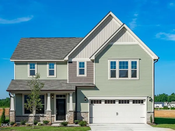 a front view of a house with garage