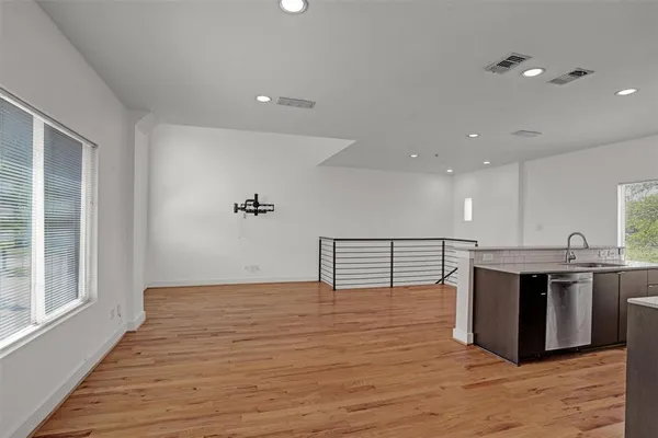 a view of kitchen with stainless steel appliances granite countertop a stove and a sink