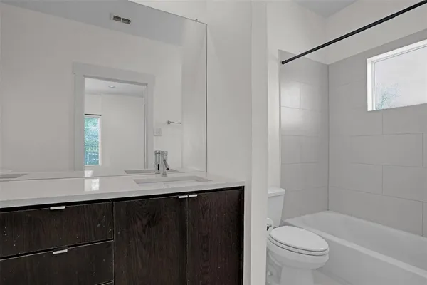 a bathroom with a granite countertop sink toilet a large mirror and shower
