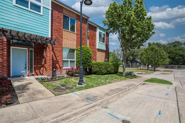 a front view of a house with a yard and trees