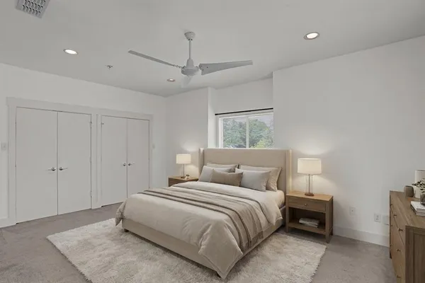 a bedroom with a bed and a night stand