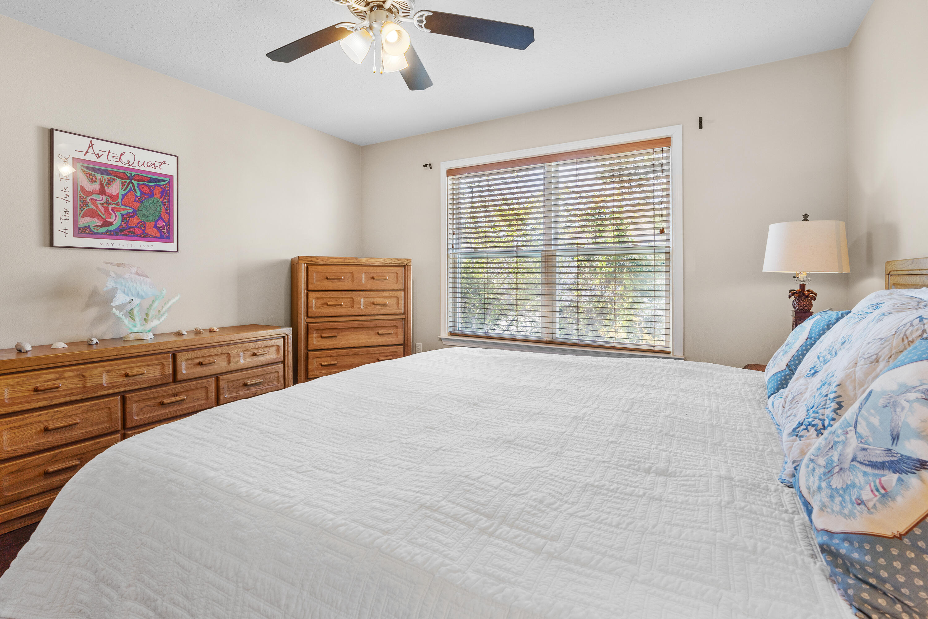 19 Topside Drive Inlet Beach, FL 32461 - Photo 29 of 40 a bedroom with a large bed and a chandelier
