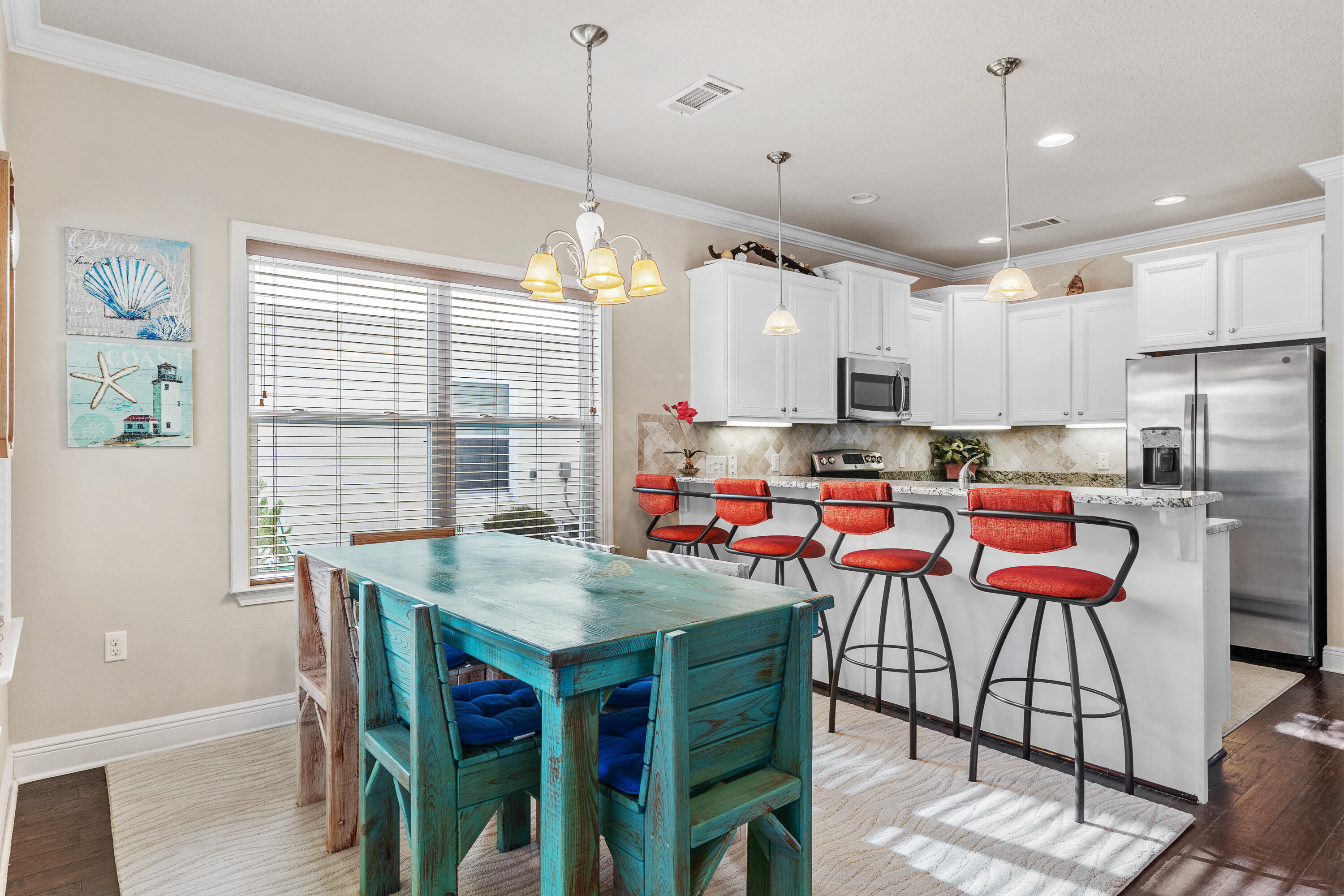 19 Topside Drive Inlet Beach, FL 32461 - Photo 5 of 40 a kitchen with stainless steel appliances granite countertop a stove a refrigerator a kitchen island a table and chairs