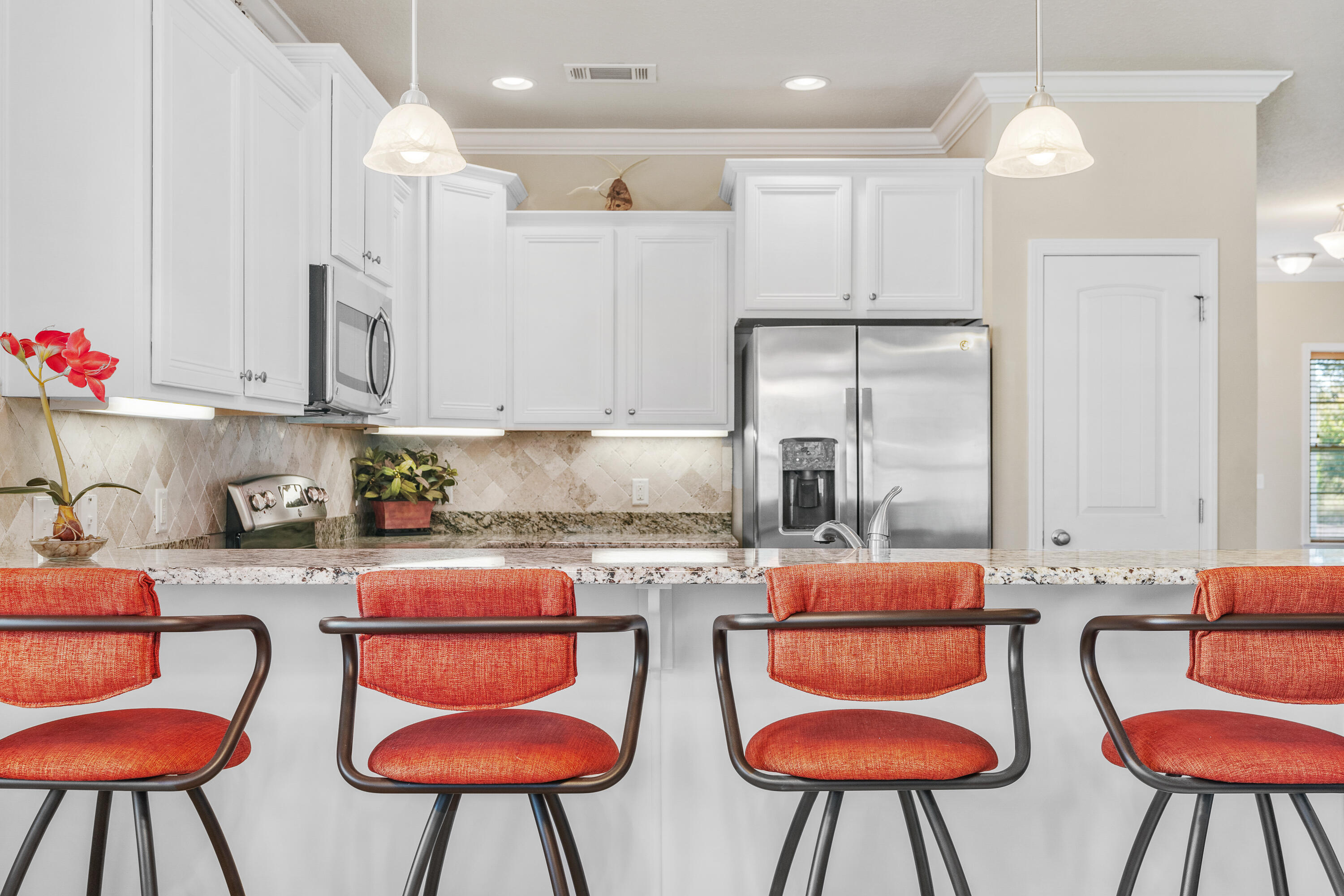 19 Topside Drive Inlet Beach, FL 32461 - Photo 7 of 40 a kitchen with stainless steel appliances granite countertop a white table chairs and a stove