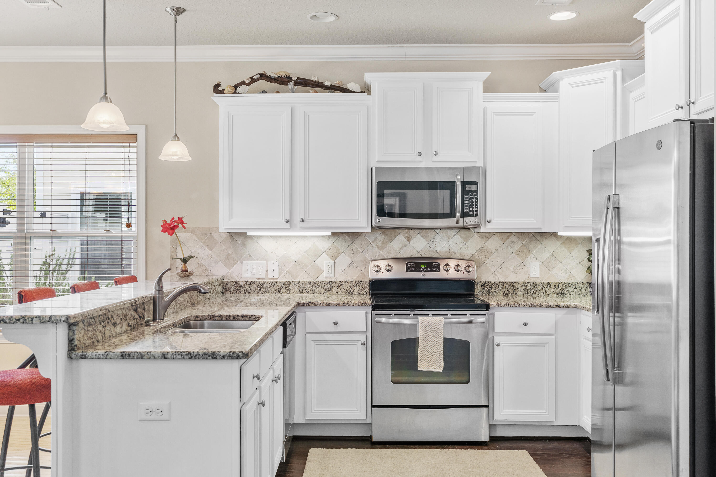 19 Topside Drive Inlet Beach, FL 32461 - Photo 9 of 40 a kitchen with stainless steel appliances granite countertop a sink stove and refrigerator