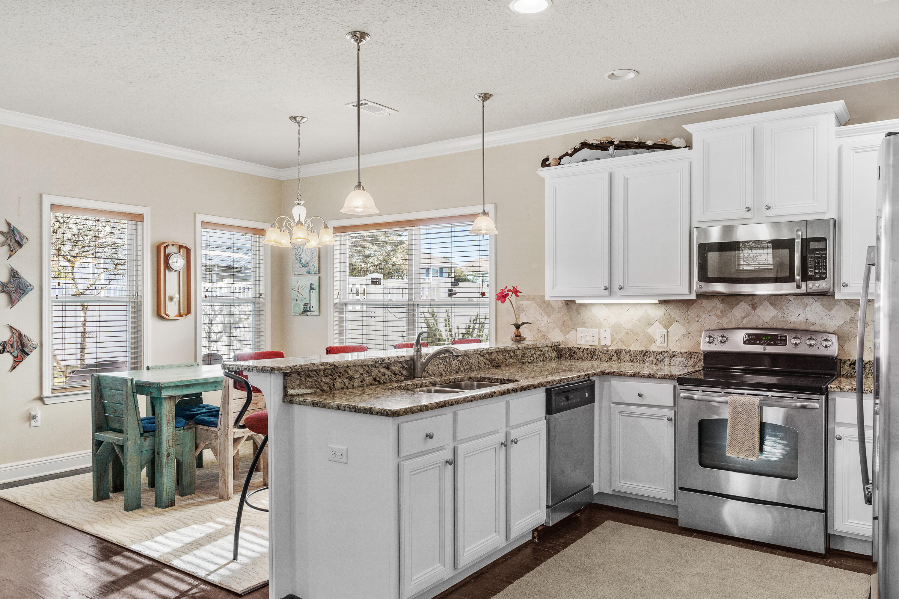 19 Topside Drive Inlet Beach, FL 32461 - Photo 10 of 40 a kitchen with stainless steel appliances granite countertop a stove a sink and white cabinets