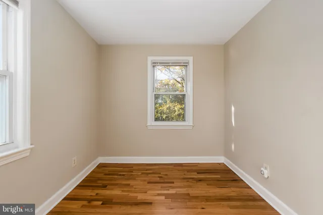 a view of room with window and wooden floor