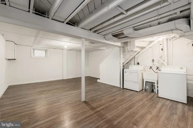 an empty room with wooden floor and a window