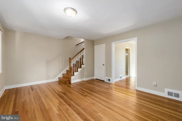 a view of a room with wooden floor and window