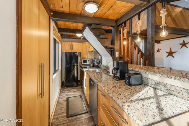 a view of an entryway with wooden floor and door