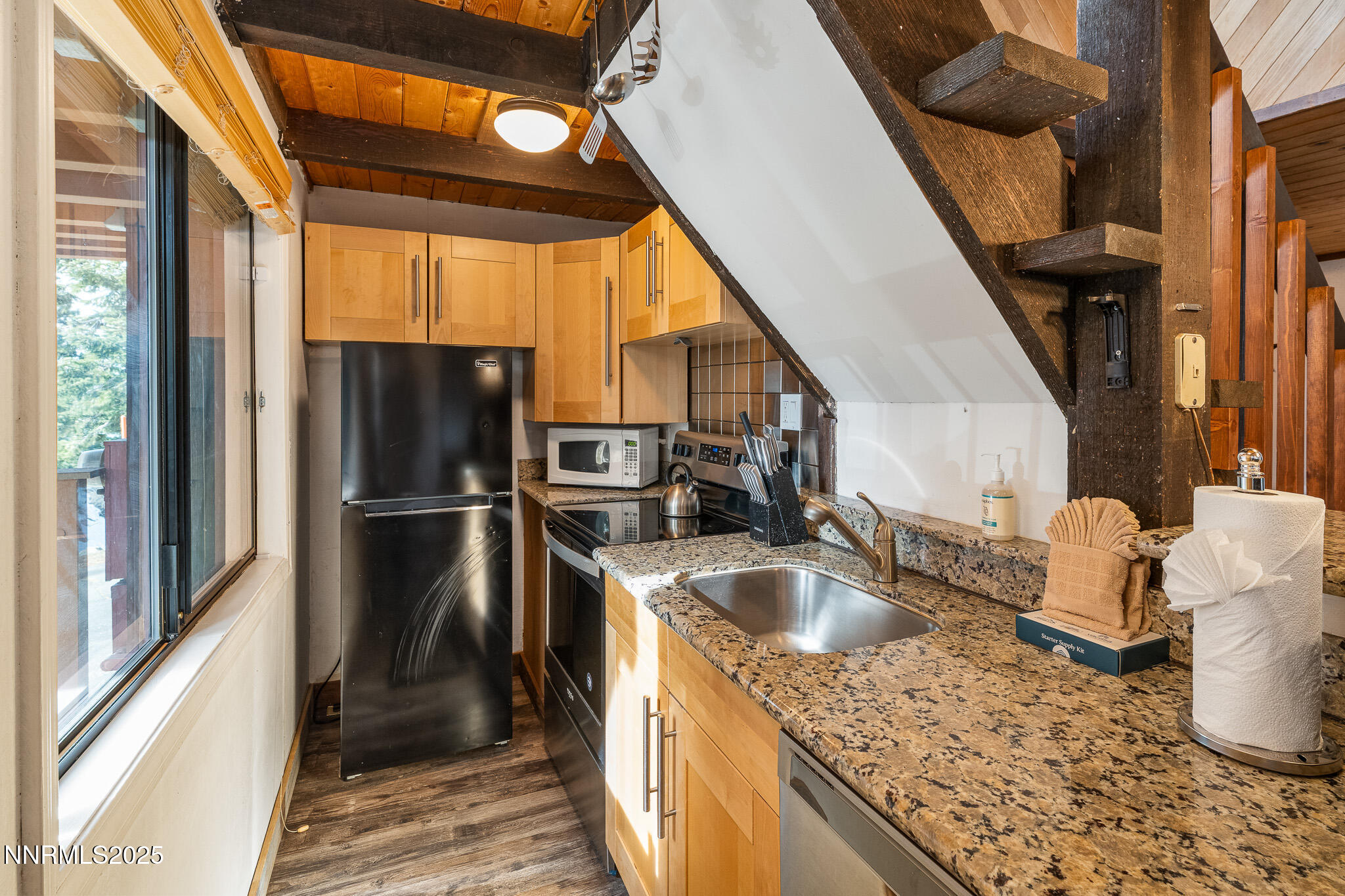 281 Orion Lane, Unit D Stateline, NV 89449 - Photo 21 of 33 a kitchen with a sink a refrigerator and washer