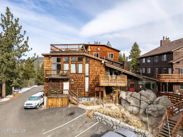 an aerial view of a house with a yard