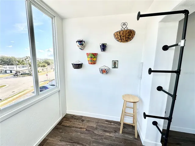 a view of a room with wooden floor and front door