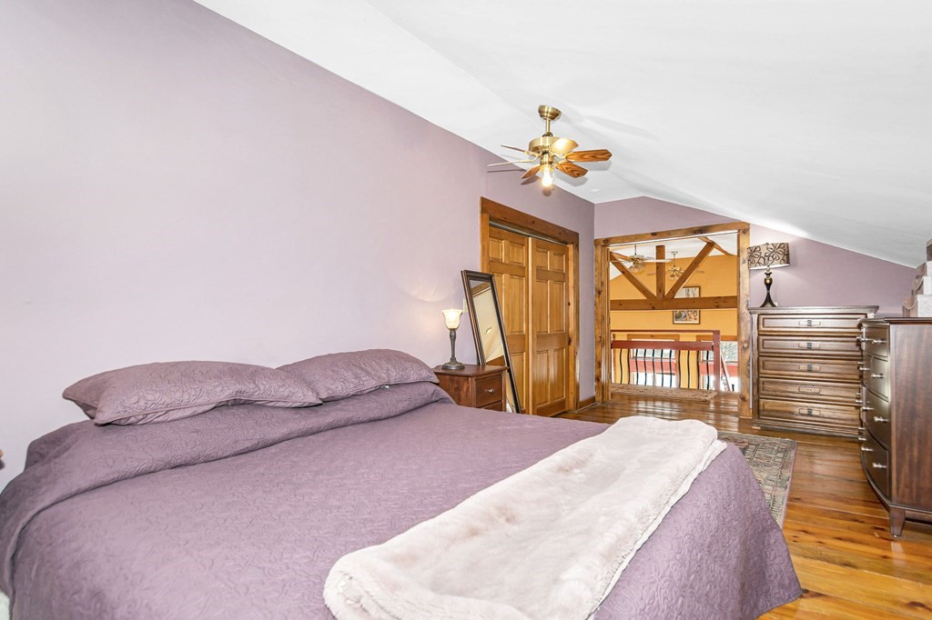 326 Mountain Road Lyndeborough, NH 03082 - Photo 23 of 41 a bedroom with a bed and a chandelier