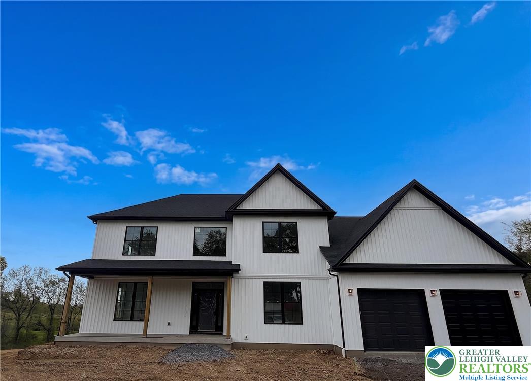 1899 Kecks Road Breinigsville, PA 18031 - Photo 2 of 30 This newly constructed residence showcases a modern farmhouse design with a striking black and white exterior.