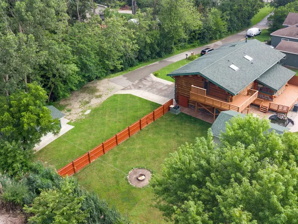 an aerial view of a house with yard