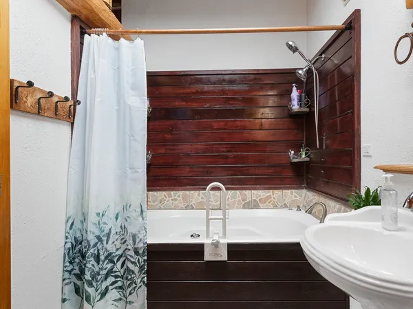 a view of a room with wooden floor and windows
