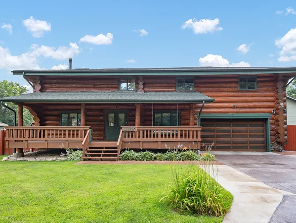 a view of backyard with deck and outdoor seating