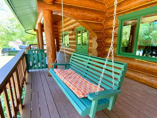 a spacious bedroom with a bed and wooden floor
