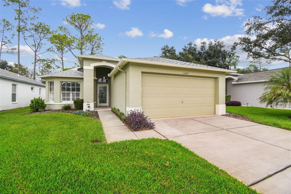 a front view of a house with a yard and garage