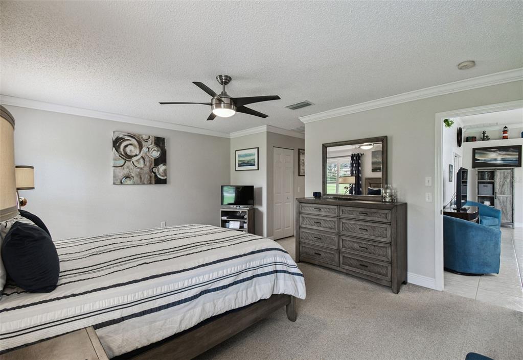 11647 Wheatfield Loop Hudson, FL 34667 - Photo 19 of 62 a bedroom with a large bed and a flat screen tv