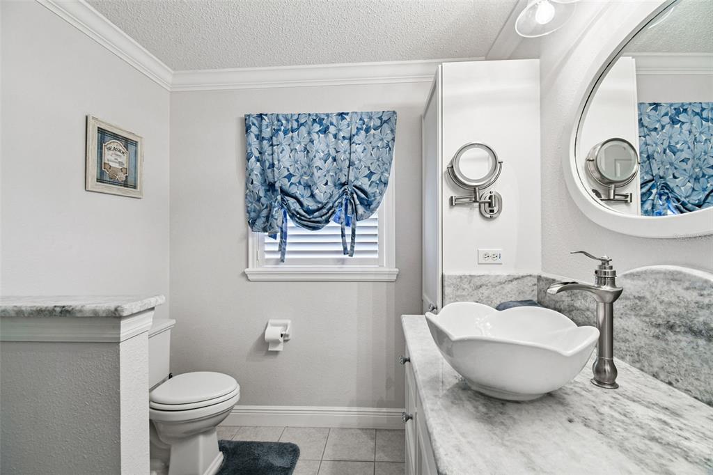 11647 Wheatfield Loop Hudson, FL 34667 - Photo 21 of 62 a bathroom with a toilet and a sink