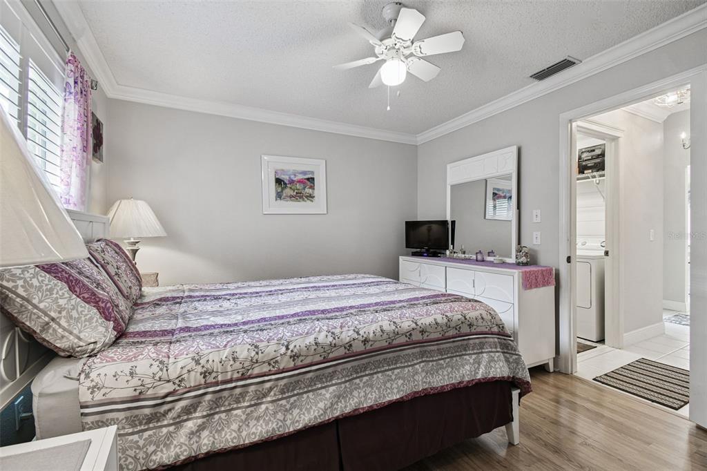 11647 Wheatfield Loop Hudson, FL 34667 - Photo 24 of 62 a bedroom with a bed and wooden floor