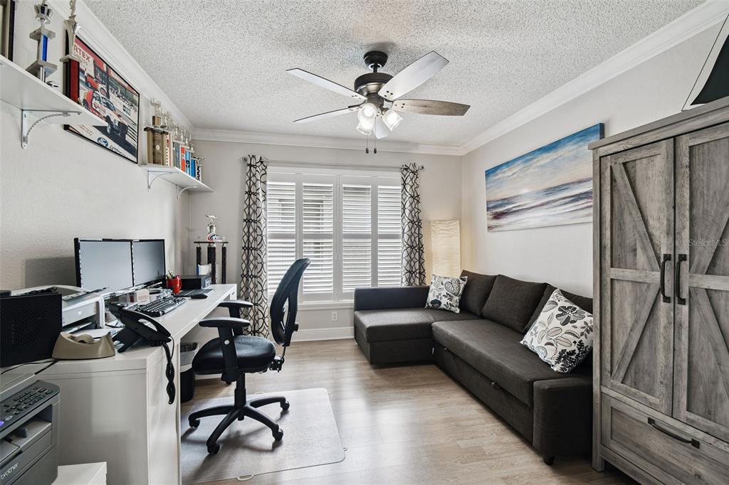 11647 Wheatfield Loop Hudson, FL 34667 - Photo 28 of 62 a living room with furniture a ceiling fan and a window