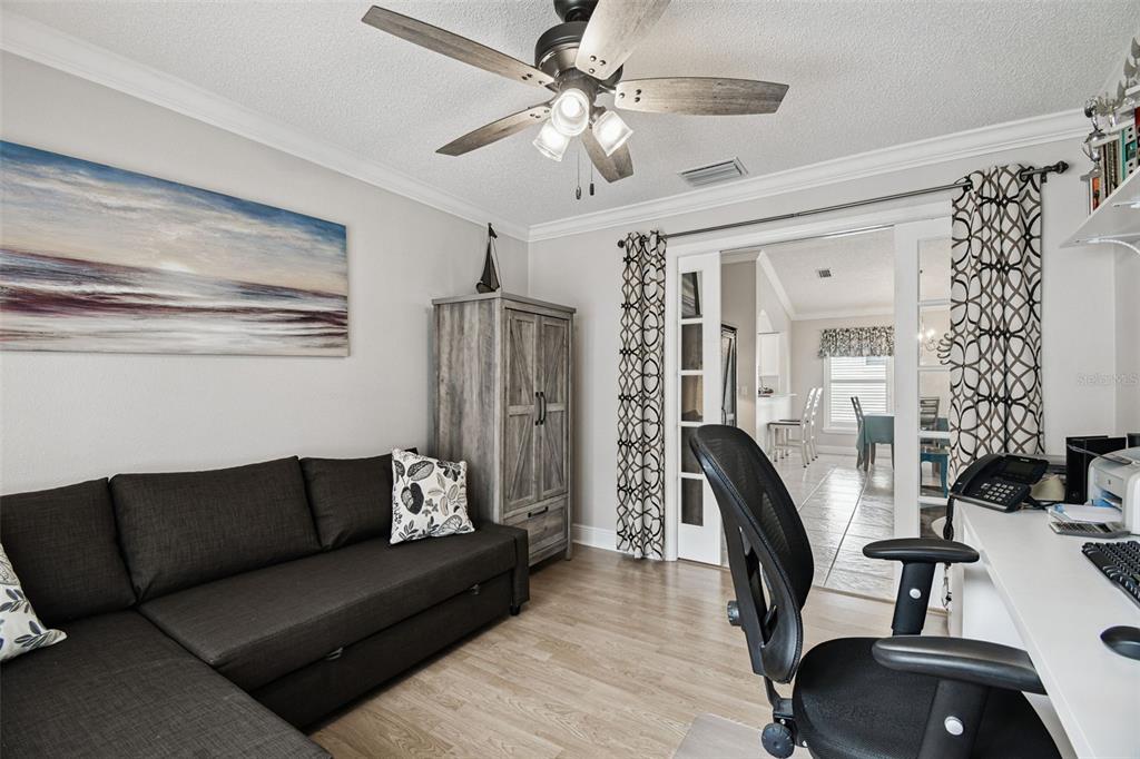 11647 Wheatfield Loop Hudson, FL 34667 - Photo 29 of 62 a living room with furniture and a chandelier