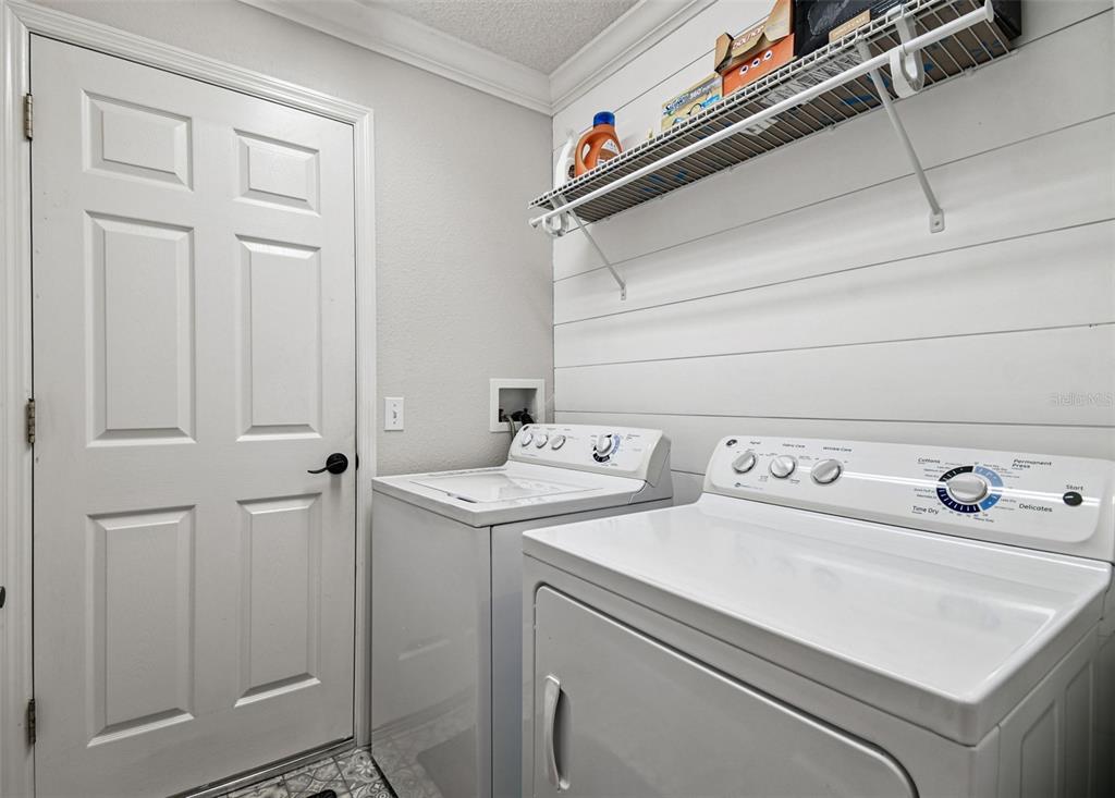 11647 Wheatfield Loop Hudson, FL 34667 - Photo 35 of 62 a utility room with dryer and washer