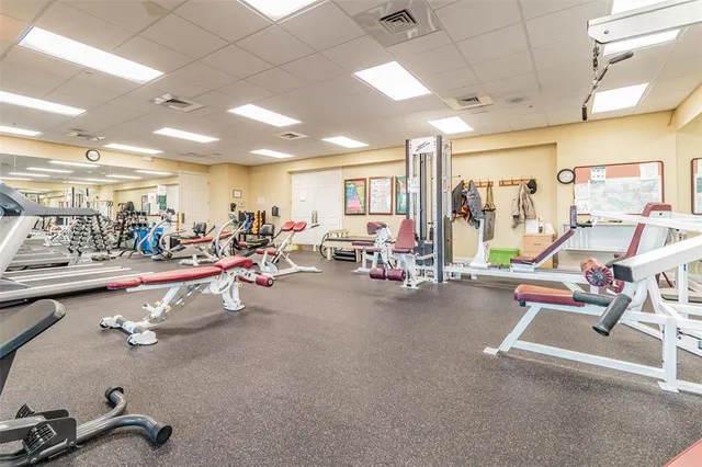 a group of people sitting at tables in a living room