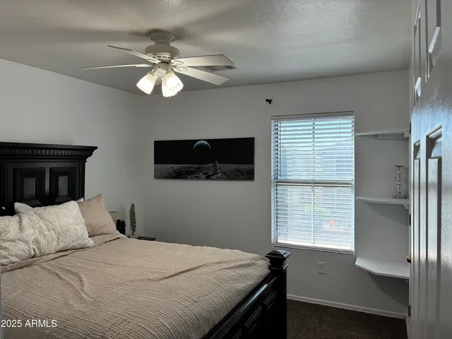 a bedroom with a bed and a potted plant
